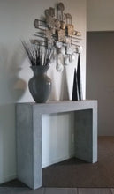 Load image into Gallery viewer, 80cm high and 100cm wide square edged concrete console table shown in urban grey colour with high and low black and grey decorative pieces displayed on top